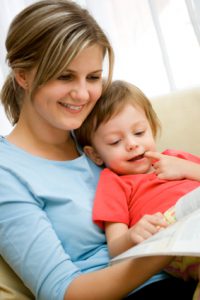mom reading to her baby
