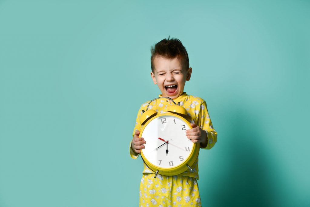 Young child holding clock - 5 Ways to Balance Work-from-Home AND Parent-from-Home