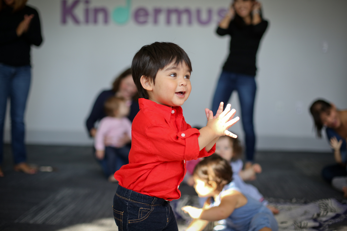 A 2-year-old dances to the beat during a music class for toddlers.