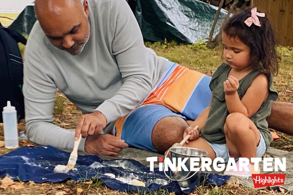 A father paints alongside his daughter. Using things like paint to recreate items from their original state is one easy way to teach creativity. 