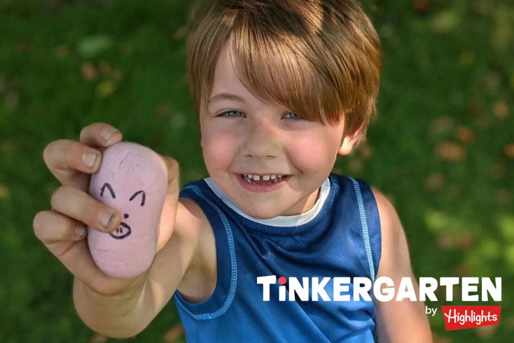 A 4-year-old boy holds up a rock he transformed with a marker. Reimagining objects from their original state is a way to teach creativity and let the child lead the activity.