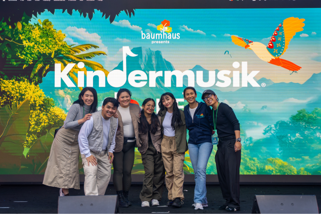 Teachers from the Hong Kong child music program Baumhaus pose for a picture at a community event.